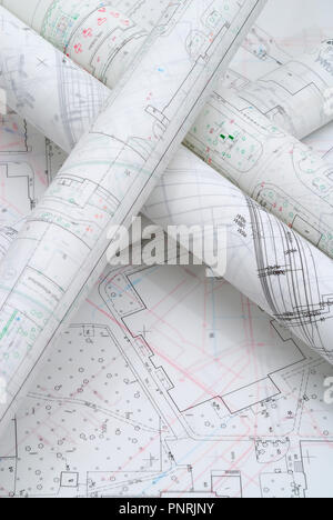 Rolled architectural plans lying on drawing board Stock Photo