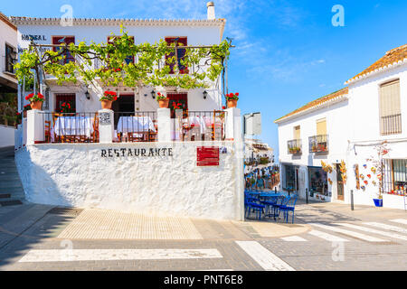 MIJAS VILLAGE, SPAIN - MAY 9, 2018: Street with restaurant building in picturesque white village of Mijas, Andalusia. Southern Spain is famous for mou Stock Photo
