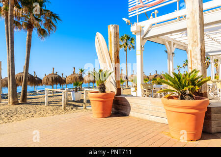 Restaurant entrance decorated with flowerpots on beach in Marbella town, Costa del Sol, Spain Stock Photo