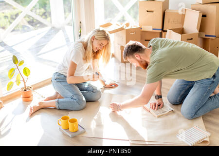 couple looking blueprints of they new house. Planning interior design Stock Photo