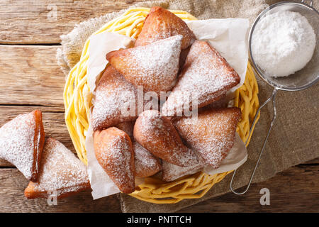 Mandazi is a slightly sweet East African Street Food; spicy, airy yeast doughnut dough made with coconut milk, flavored with cardamom and grated fresh Stock Photo