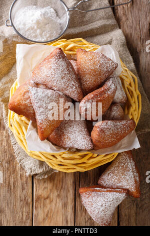 Mandazi is a slightly sweet East African Street Food; spicy, airy yeast doughnut dough made with coconut milk, flavored with cardamom and grated fresh Stock Photo