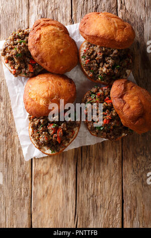 Delicious South African Vetkoek fried donuts stuffed with minced meat close-up on the table. Vertical top view from above Stock Photo