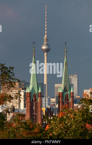 View from Viktoriapark through the spires of Saint Bonifatius Church onto Berlin TV Tower, Germany Stock Photo