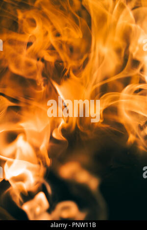Shot of fire flames and glowing ashes on black background Stock Photo