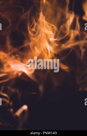 Shot of fire flames and glowing ashes on black background Stock Photo