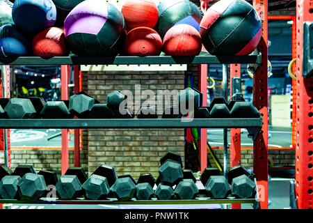 Equipment for a sports hall. Dumbbells and balls lying on the shelves. Gym.