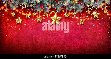 Christmas Card - Fir Garland With Hanging Stars On Red Wall Stock Photo