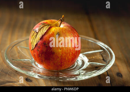 genuine and organic apple on a glass saucer Stock Photo