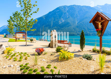 ACHENSEE LAKE, AUSTRIA - JUL 31, 2018: Coastal promenade with flowers at Achensee lake on sunny summer day, Tirol. During summer this place is very po Stock Photo