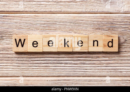 weekend word written on wood block. weekend text on table, concept. Stock Photo