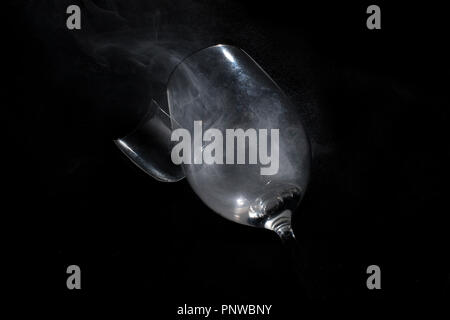 Broken wine glass, isolated on black background. Stock Photo
