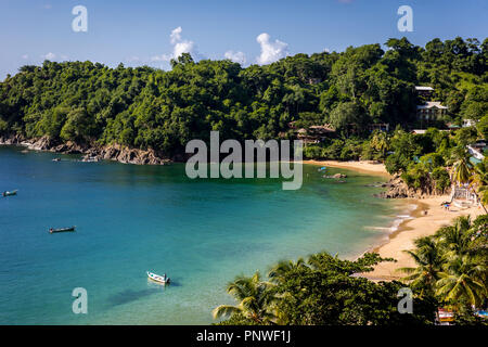 Beautiful tropical beach in Trinidad and Tobago, Caribe - blue sky, trees, sand beach, wood boats Stock Photo