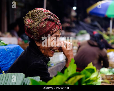 An elderly lady manning a market stall in Bali, Indonesia Stock Photo