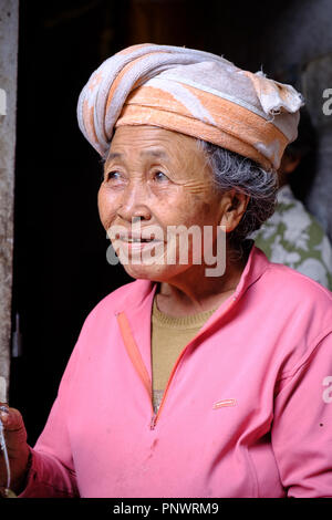 An elderly lady manning a market stall in Bali, Indonesia Stock Photo