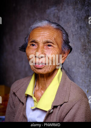 An elderly lady manning a market stall in Bali, Indonesia Stock Photo