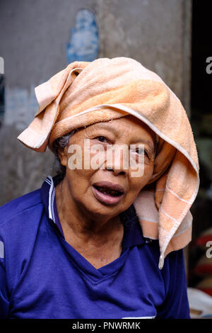 An elderly lady manning a market stall in Bali, Indonesia Stock Photo