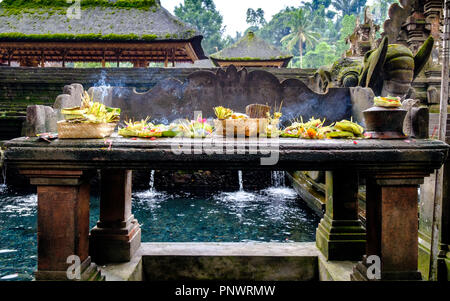 Canang sari or daily offering on a shrine at the Pura Tirta Empul temple  on Bali, Indonesia Stock Photo