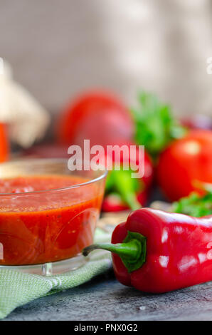 Mixed tomatoes and chilli sauce in bowl on table.  Homemade, healthy vegetarian food. Stock Photo