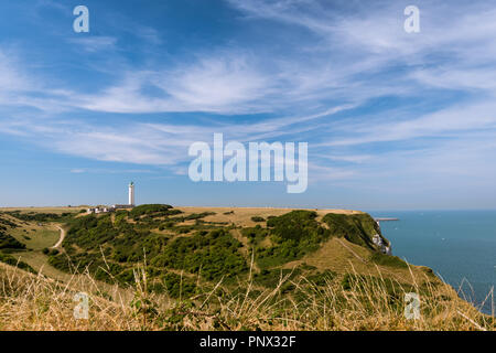 Chalk cliffs near Etretat (Normandy France) with lighthouse Phare d'Antifer on a sunny day in summer Stock Photo