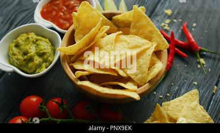 Nachos and sauces on table  Stock Photo