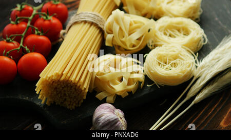 Dry pasta assortment on board Stock Photo