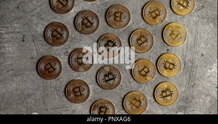Golden bitcoins on gray surface Stock Photo
