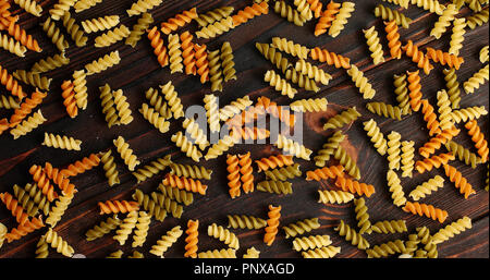Messy arrangement of pasta on wood Stock Photo