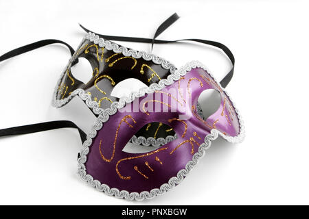 Black and Purple Venetian Masks with Gold Trim on White Background with Soft Shadow Stock Photo