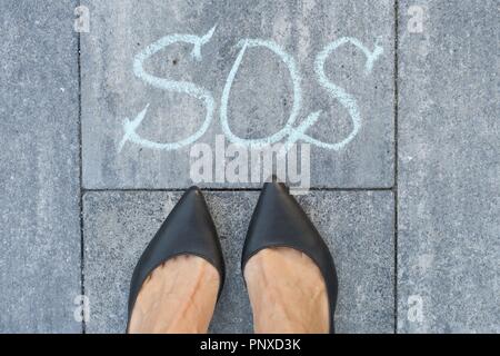 Woman and the word sos Stock Photo