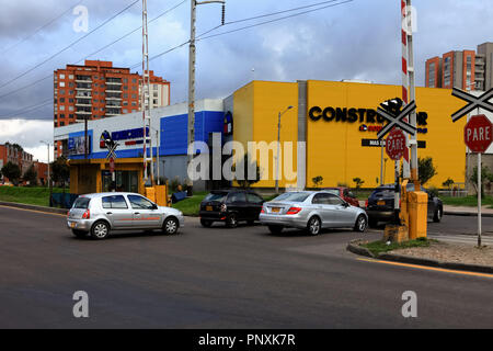 Bogotá, Colombia - May 01, 2017: Traffic moves across the northbound carriage way of Carrera Novena or Avenue 9, across a railroad crossing. Stock Photo