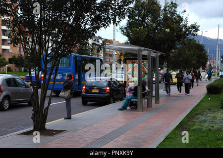 Bogotá, Colombia - May 01, 2017: Looking southwards on Carrera Novena or Avenue 9, some people are seen waiting for their bus at a bus stop. Stock Photo