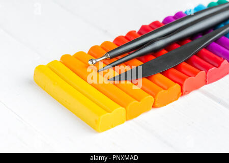 Multi-colored set of plasticine with stacks on a white background. Stock Photo