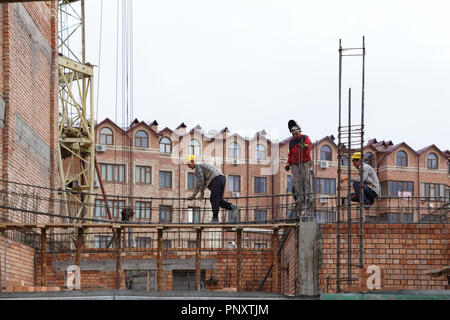 Tashkent, Uzbekistan - May 08, 2017: Three unknown men working in the construction site at Mahalla. Stock Photo