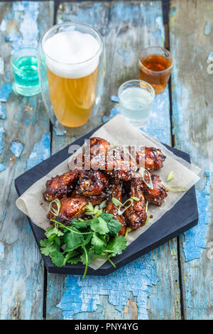 Buffalo chicken wings with beer, rustic background, copy space Stock Photo