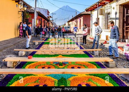 Antigua, Guatemala -  March 25, 2018: Agua volcano & Palm Sunday procession carpet in UNESCO World Heritage Site. Stock Photo