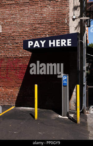 'Pay Here' sign at public parking lot, in downtown Los Angeles, California. Stock Photo