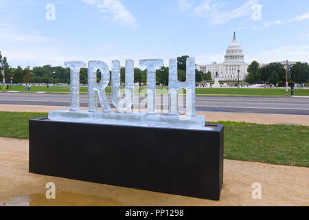 Washington DC, USA. 22 September 2018.  Truth Be Told, the melting ice sculpture exhibit on National Mall. The message with the US Capitol on background is “Is Truth Melting Away?” Credit: Andrei Medvedev/Alamy Live News Stock Photo