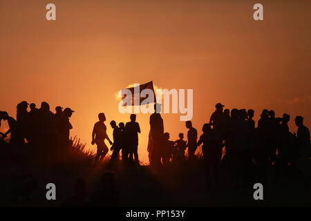 Beijing, China. 17th Sep, 2018. Palestinian protestors are silhouetted against sunshine during clashes with Israeli troops near the border between the north Gaza Strip and Israel, on Sept. 17, 2018. Credit: Stringer/Xinhua/Alamy Live News Stock Photo