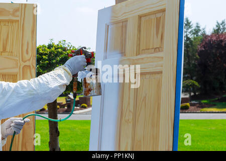 Close up of master painting spray gun wood doors Stock Photo Alamy