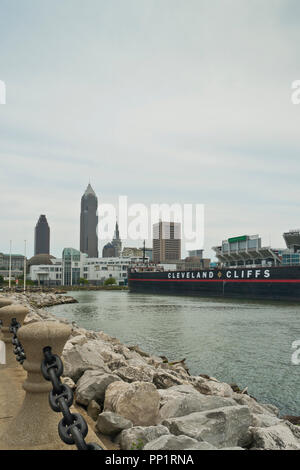 CLEVELAND - AUGUST 26: View of the Cleveland skyline from Voinovich Park, featuring Cleveland Cliffs' William G. Mather freighter on a mostly cloudy s Stock Photo