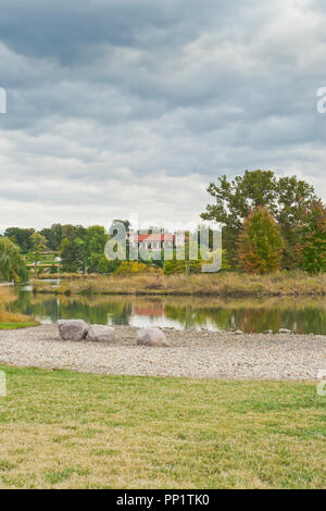 A receding sheet of low clouds over the World's Fair Pavilion, the Post-Dispatch Lake, a birdhouse, and rocks at Forest Park. Stock Photo
