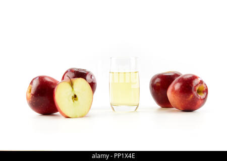 apples whole and half and a glass of apple juice isolated on white background. Stock Photo
