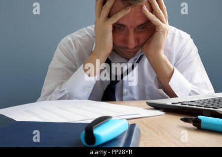Stress Management. Overworked and exhausted man in the office. Stock Photo