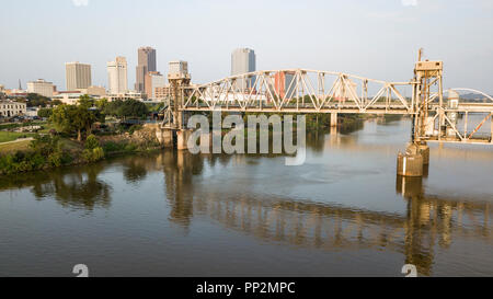 The capitol city of Arkansas in Little Rock is behind the transformed railroad bridge Stock Photo