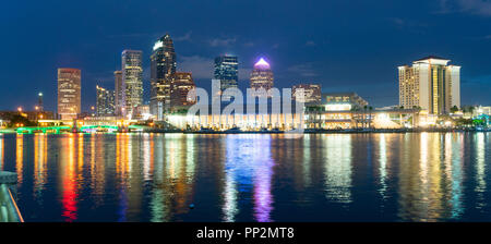 Night falls as lights come up on buildings beginning a beautiful summer evening in Tampa Florida downtown Stock Photo