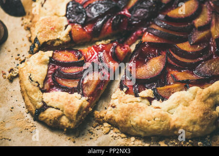 Plum galetta sweet cake dessert on baking paper, horizontal composition Stock Photo