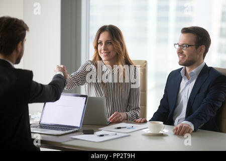 Diverse colleagues shaking hand during business meeting in offic Stock Photo