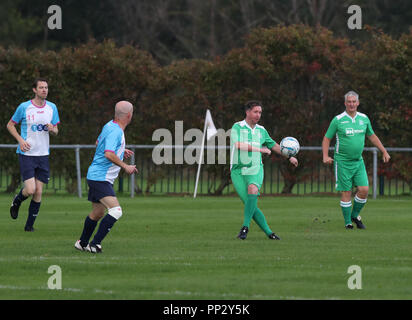 Former Liverpool FC and England striker Robbie Fowler kicks the ball during the Labour (in green) v Journalists annual football match at Walton Park in Liverpool during the party's annual conference in the city. Stock Photo