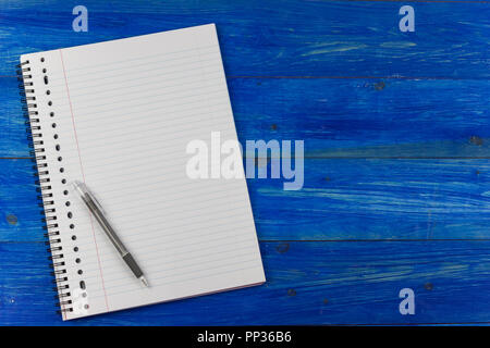 Notepad and pen on a blue wooden table Stock Photo